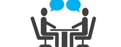 Stick people talking across a table