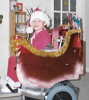 Emma dressed up as Santa in his sleigh - December 2001