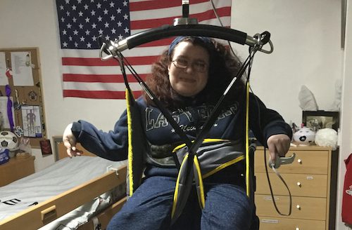 Emma being hoisted out of her wheelchair