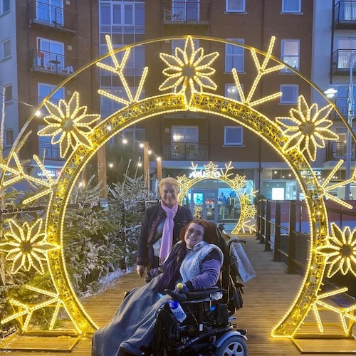 Carol and Emma under Christmas light arch at Gunwharf Quays