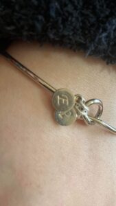 Silver bracelet with a friendship knot and the letters, E and P
